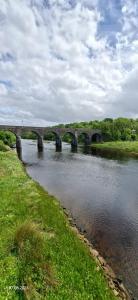 a bridge over a river with a bridge over water at Rosmore Newport in Newport