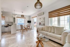 a living room with a couch and a table at Pallas in Keratea +23 photos