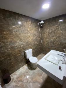 a bathroom with a toilet and a sink at Tucanos Club in São Paulo +10 photos