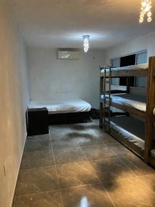 a room with two bunk beds and a tiled floor at Tucanos Club in São Paulo