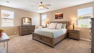 a bedroom with a bed and two dressers and a mirror at Temecula Valley 4BR - Pool Table & Fenced Yard in Winchester