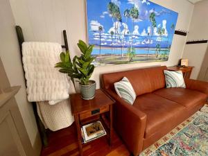 a living room with a couch and a painting on the wall at Casa Del Sol Historic St Aug Hideaway in St. Augustine