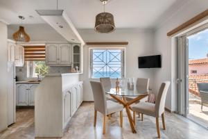 a kitchen and dining room with a table and chairs at Pallas in Keratea