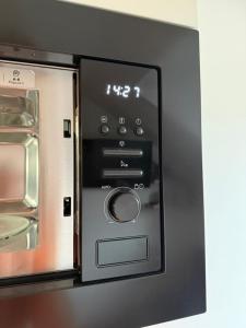 a microwave oven with the door open on a kitchen at Apartament Lubię Błękit in Rowy