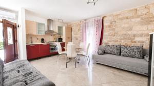 a living room with a couch and a table at Apartment Romić in Omiš