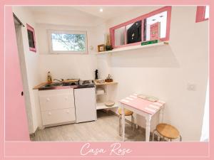 a small kitchen with a table and a sink at Casa Rose, Petit cocon avec jardin dans un quartier calme de Toulon in Toulon