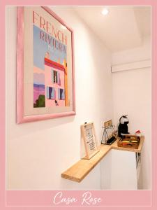 a painting hanging on a wall next to a desk at Casa Rose, Petit cocon avec jardin dans un quartier calme de Toulon in Toulon
