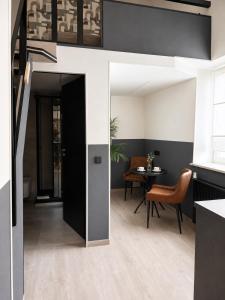 a kitchen and dining room with a black door and a table at Rheinischer Hof Duisburg in Duisburg