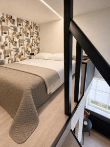 a bedroom with a large bed and a staircase at Rheinischer Hof Duisburg in Duisburg