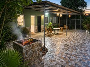 a patio with a fire pit in front of a house at PINE-APPALE Riverside Resort in Ấp Kế Mỹ