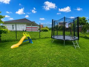 a swing set and a trampoline in a yard at Ferienwohnungen Nahrstedt in Waldeck