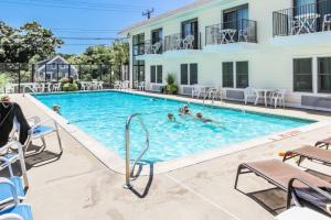 a swimming pool at a hotel with people in it at Holly Tree Resort - Studio in Yarmouth