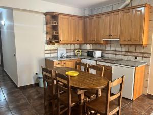 a kitchen with a wooden table and wooden cabinets at Apartamentos Esencia vistas al embalse 2 in Hornos +10 photos