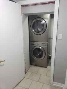 a laundry room with a washer and dryer in it at Beautiful home in Brampton +7 photos