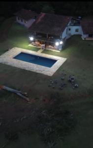 an aerial view of a swimming pool at night at Vista Joah in Joanópolis