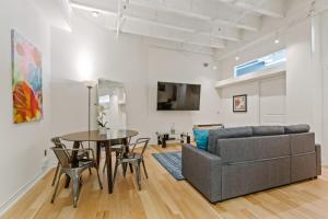 a living room with a couch and a table at Rooftop Pool & City Views! Long-Term Dtwn LA Stay in Los Angeles