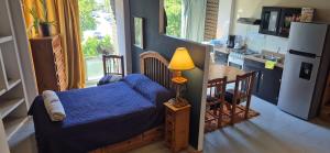 a bedroom with a bed and a lamp on a table at Edificio Bermejo Suites in La Paz