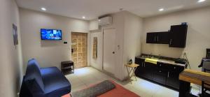 a living room with a couch and a tv on the wall at Edificio Bermejo Suites in La Paz