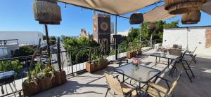 a patio with tables and chairs on a balcony at Edificio Bermejo Suites in La Paz