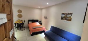 a living room with a blue couch and a table at Edificio Bermejo Suites in La Paz