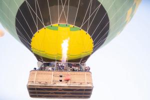 a hot air balloon with people inside of it at Luxor hot air balloon co in Jazīrat al ‘Awwāmīyah +5 photos