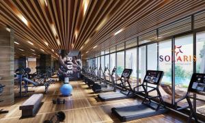 a gym with a row of treadmills and machines at 1bedroom at Solaris in Accra