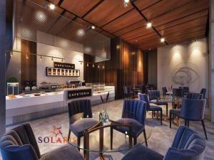 a restaurant with blue chairs and tables and a counter at 1bedroom at Solaris in Accra