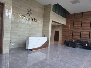 a lobby of a building with a stone wall at 1bedroom at Solaris in Accra