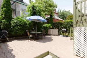 a patio with a table and an umbrella at Perfect Studio with AC near NYC in West New York