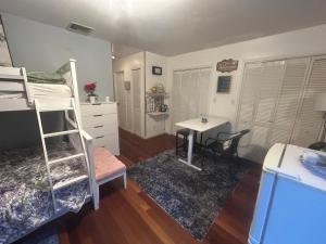 a dorm room with a bunk bed and a desk at Perfect Studio with AC near NYC in West New York