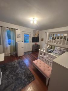 a bedroom with a bunk bed and a crib at Perfect Studio with AC near NYC in West New York