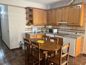 a kitchen with a wooden table and wooden cabinets at Apartamentos Esencia vistas embalse 1 in Hornos +7 photos