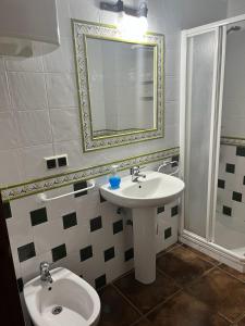 a bathroom with a sink and a toilet and a mirror at Apartamentos Esencia vistas embalse 1 in Hornos