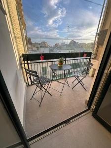 a balcony with a table and chairs on a balcony at Amena Sea & City in Brindisi