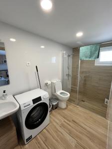 a bathroom with a washing machine and a toilet at Eko apartamentos Astelarra in Muxika +72 photos