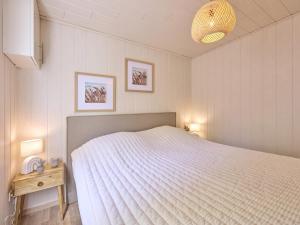 a bedroom with a bed with a white bedspread at Barri in Zutendaal