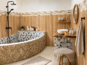 a bathroom with a large tub and a sink at PINE-APPALE Riverside Resort in Ấp Kế Mỹ