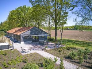 a small shed with a table and chairs in a field at Guesthouse het Koetshuis in Bladel