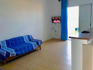 a living room with a blue couch in a room at Résidence R in Ksour Essaf