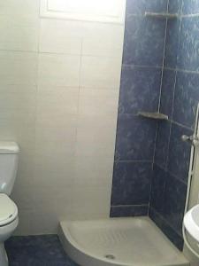 a bathroom with a shower and a toilet and a sink at Résidence R in Ksour Essaf +13 photos