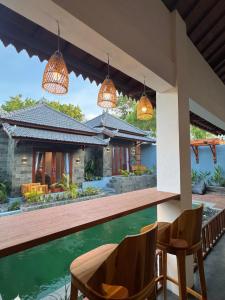 a view of a house with a bar and chairs at SinCity Nature Private Pool Villa in Tanjung