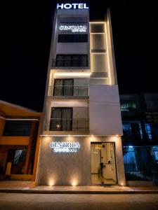 a hotel with a sign on the side of a building at Centrica Suite Hotel in Huarmey