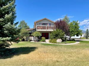a large house with a porch and a yard at The Penthouse in Ennis