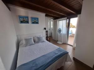 a bedroom with a bed and a door to a patio at Las Olas Corralejo beach in Corralejo +42 photos