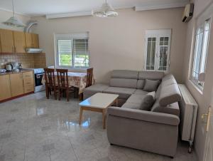 a living room with a couch and a table at Vila Albert in Gjirokastër