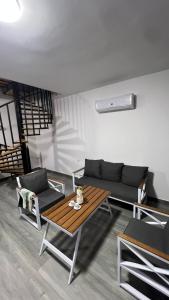 a living room with a couch and a wooden table at OASIS360 chalet in Sowayma +1 photo