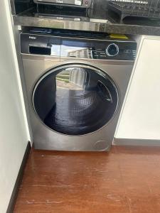 a washing machine with its door open in a kitchen at Container Glamping in Zapopan
