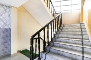 a staircase in a building with a window at Hotel O Priyal in Chās