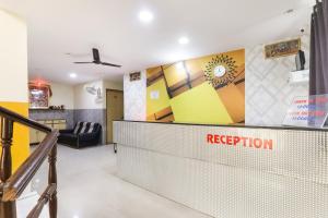 a lobby with a reception desk and a waiting room at Hotel O Priyal in Chās