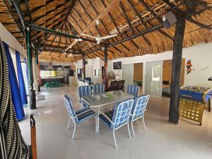 a dining room with a table and blue chairs at PLAYABRISAMAR in San Antero